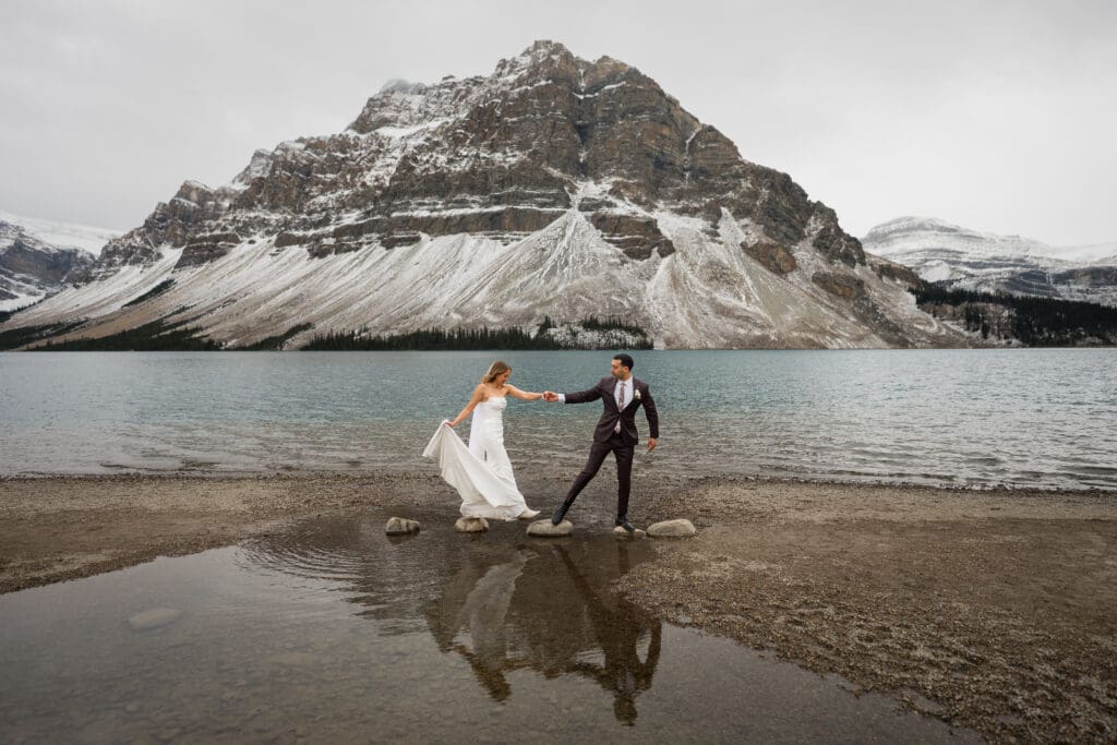 Couple at bow lake in banff during classic mountain elopement
